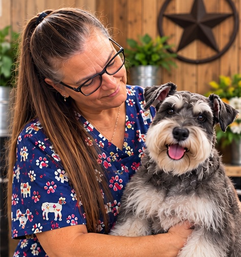 Lisa holding a Miniature Schnauzer during a grooming visit